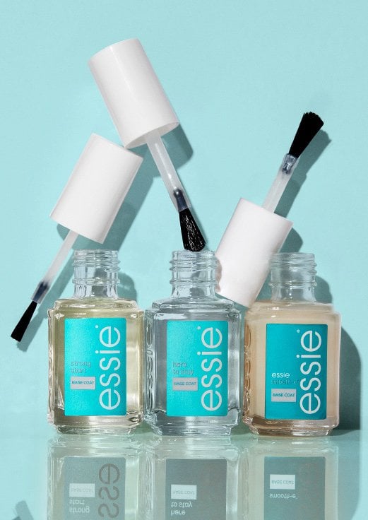 Three of Essie's base coats and primers against a light blue background